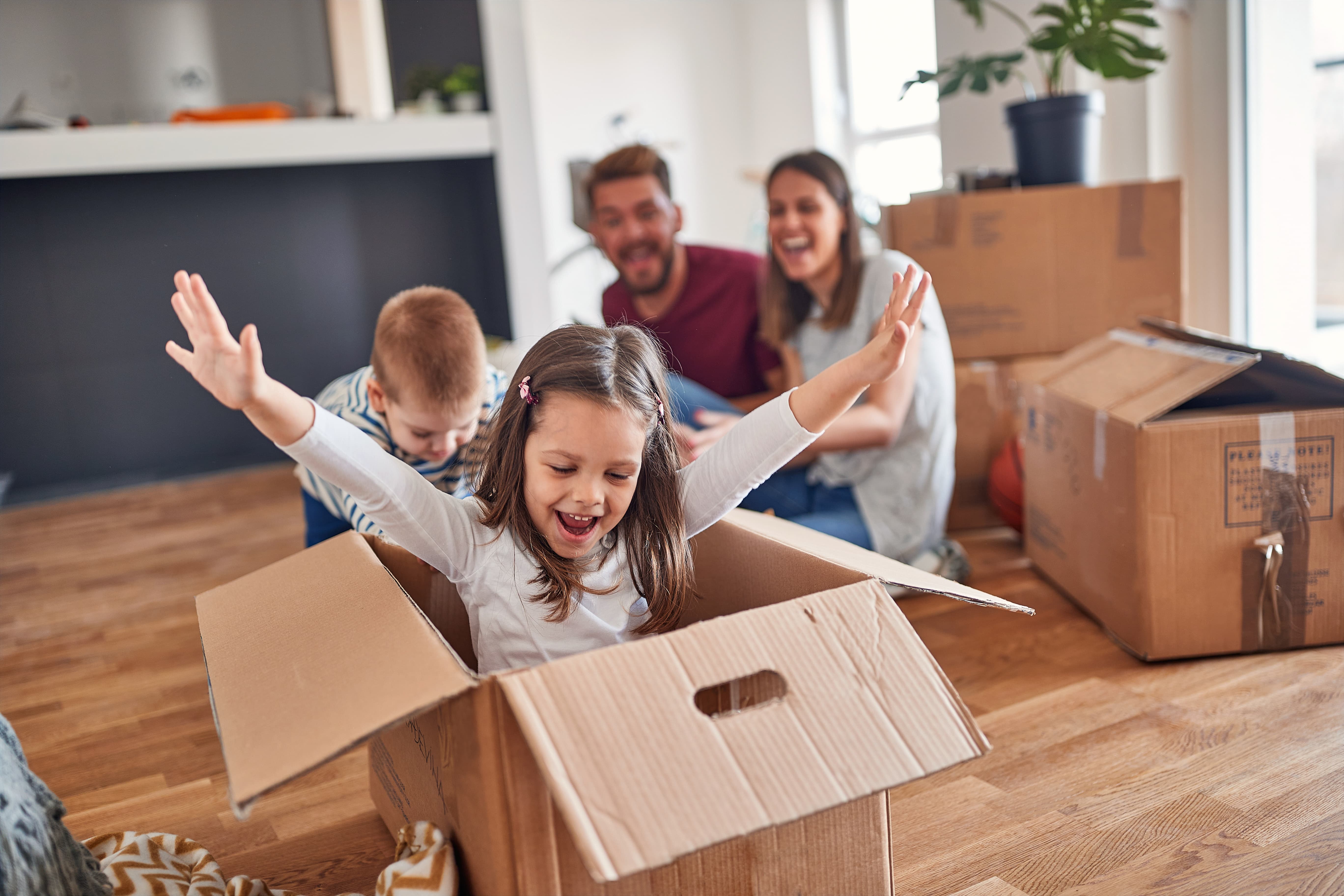 Moving This Summer? How to Find Your Power Company and Set Up Electricity Fast_Family Packing Up Boxes